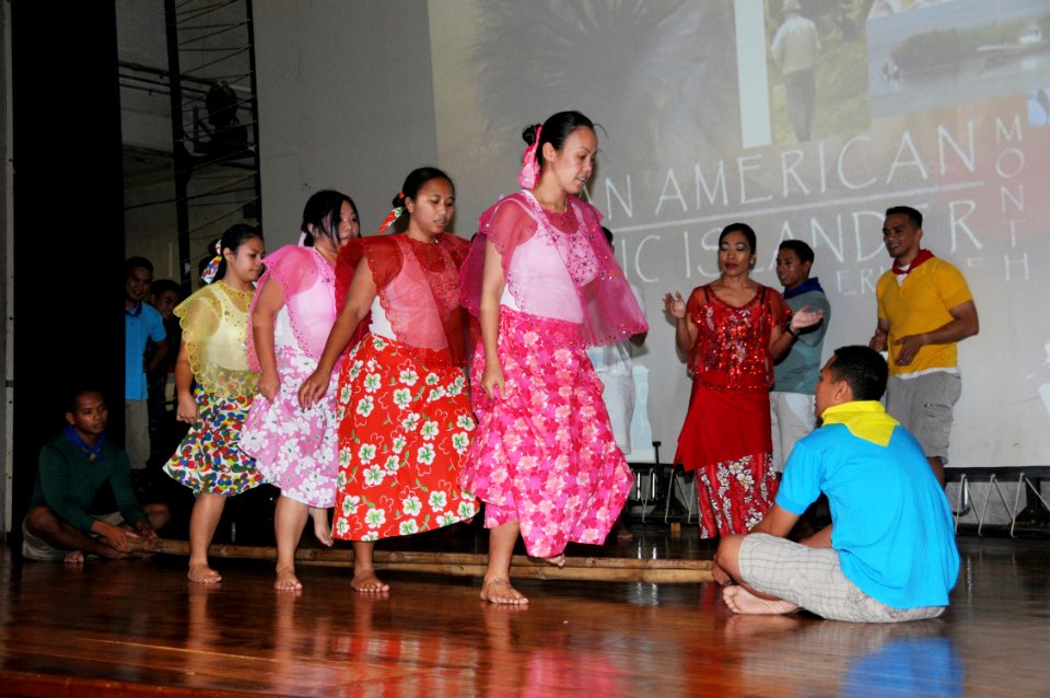 US Navy 100525-N-1906L-006 Hospital Corpsman 2nd Class Jade Zimmerman, right, leads a troupe of tinikling dancers from U.S. Naval Hospital Guam during an Asian and Pacific American Heritage Month celebration