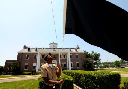 US Navy 100524-N-5328N-633 Cryptologic Technician (Technical) Seaman Antron Johnson-Gray, a student at the Center for Information Dominance Corry Station, raises the black flag for the first time in 2010