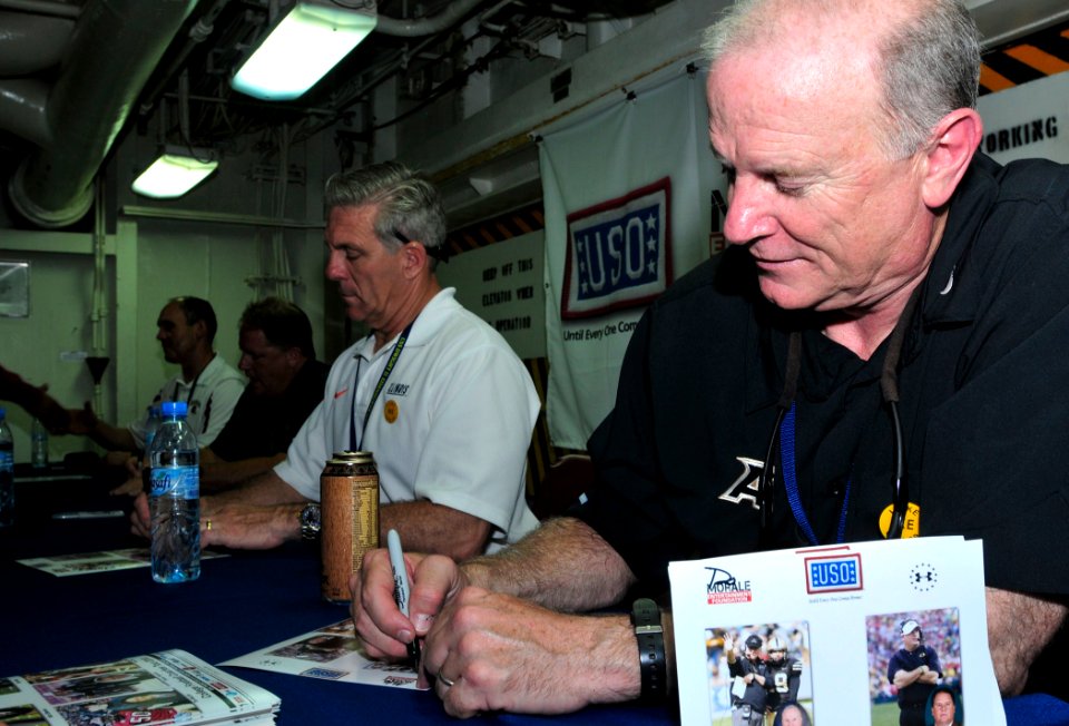 US Navy 100527-N-3595W-003 Army football coach Rich Ellerson signs autographs for Sailors aboard the aircraft carrier USS Dwight D. Eisenhower (CVN 69) as part of a Morale Entertainment and USO-sponsored 2010 Coaches Tour