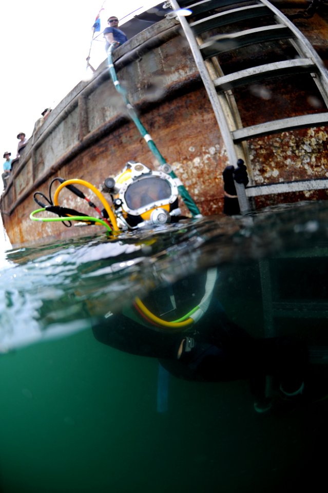 US Navy 100525-N-0413B-022 Brick Bradford, a retired Master Diver assigned to Joint POW-MIA Personnel Accounting Command (JPAC), prepares to participate in a dive