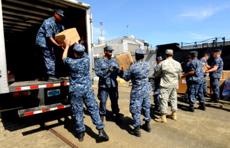 US Navy 100526-N-9643W-280 Sailors assigned to High Speed Vessel Swift (HSV 2) load Project Handclasp donations into vehicles on the pier for several organizations in Panama City, Panama