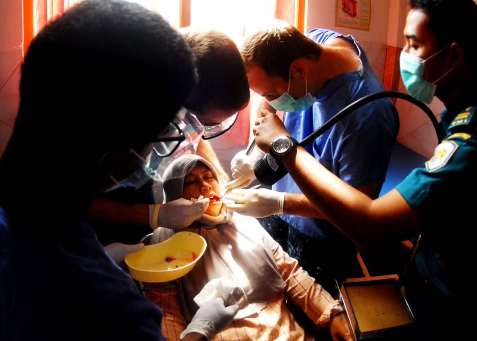 US Navy 100527-N-0995C-062 U.S. and Indonesian navy dental officers extract a tooth from an Indonesian woman as part of a medical and dental civic action project conducted for Naval Engagement Activity Indonesia 2010