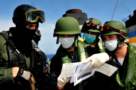 US Navy 100527-N-7364R-217 Portuguese navy visit, board, search and seizure team members verify ship documents aboard the Military Sealift Command container and roll-on-roll-off ship USNS LCPL Roy M. Wheat (T-AK 3016)