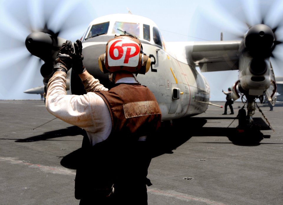 US Navy 100525-N-4236E-073 Sailors perform pre-flight checks on a C-2A Greyhound
