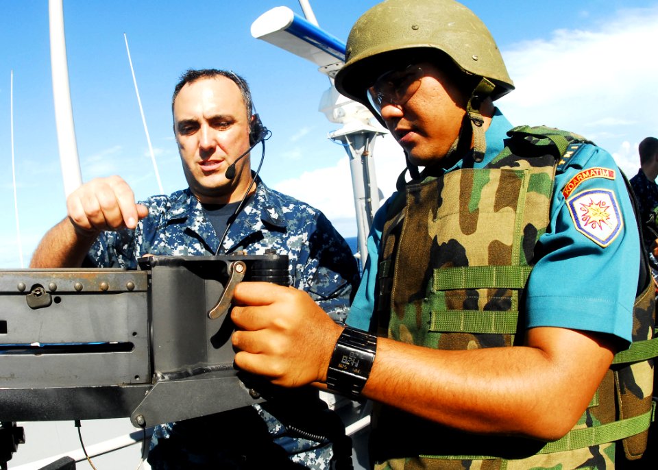 US Navy 100528-N-0995C-083 Gunner's Mate 1st Class Chad Schrine instructs an Indonesian National Armed Forces sailor