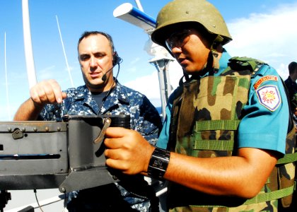 US Navy 100528-N-0995C-083 Gunner's Mate 1st Class Chad Schrine instructs an Indonesian National Armed Forces sailor