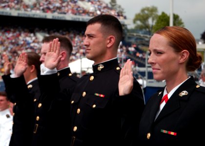 US Navy 100528-N-3857R-230 Marine Corps graduates from the U.S. Naval Academy Class of 2010 raise their right hands to take the oath of office during their graduation and commissioning ceremony photo