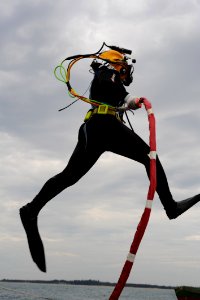 US Navy 100527-N-0413B-010 Navy Diver 3rd Class Jordan Wingard, assigned to Mobile Diving Salvage Unit (MDSU) 1, jumps off a barge for a dive supporting a Joint POW-MIA Personnel Accounting Command (JPAC) recovery mission