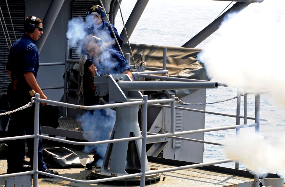 US Navy 100526-N-7280V-023 Fire Controlman 3rd Class Patrick Ramos and Gunner's Mate 2nd Class Joshua Pacheco test fire a 40mm saluting battery in preparation for the U.S. 7th Fleet change of command ceremony
