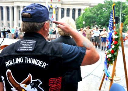 US Navy 100529-N-4178C-002 Lt. Cmdr. Pete Zaleski (ret.) renders a salute during colors at the Rolling Thunder wreath-laying ceremony at the U.S. Navy Memorial