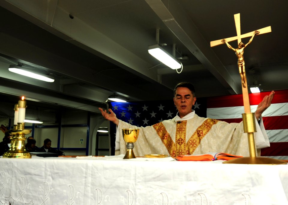 US Navy 100529-N-7191M-027 Father Jose Pimentel performs Catholic Mass for Sailors aboard USS George Washington (CVN 73)