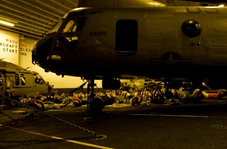 US Navy 100527-N-7948R-186 Sailors and Marines work out in the hangar bay aboard the amphibious assault ship USS Peleliu (LHA 5)