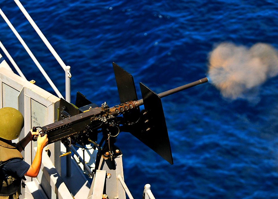 US Navy 100530-N-7643B-232 Cryptologic Technician (Technical) Seaman Nicholas Killion fires the .50-caliber machine gun at a target as part of a surface gunnery exercise aboard USS Tortuga (LSD 46)