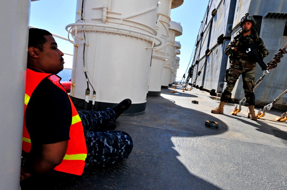 US Navy 100527-N-7364R-098 A Spanish navy visit, board, search and seizure team member stands guard over a detained crewmember aboard the Military Sealift Command container and roll-on-roll-off ship USNS LCPL Roy M. Wheat (T-AK