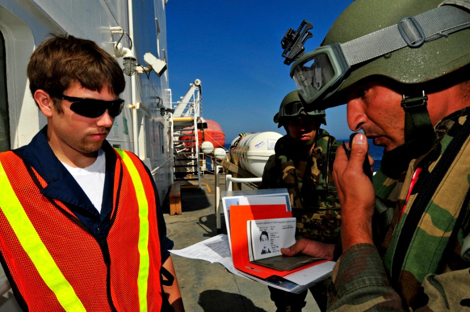 US Navy 100527-N-7364R-131 A Spanish navy visit, board, search and seizure team member verifies identification of a crewmember aboard the Military Sealift Command container and roll-on-roll-off ship USNS LCPL Roy M. Wheat (T-AK