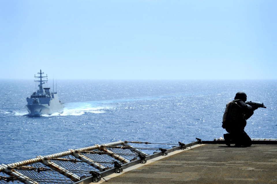 US Navy 100528-N-3136P-056 An Italian navy visit, board, search and seizure team member secures the flight deck aboard the Military Sealift Command container and roll-on-roll-off ship USNS LCPL Roy M. Wheat (T-AK 3016)