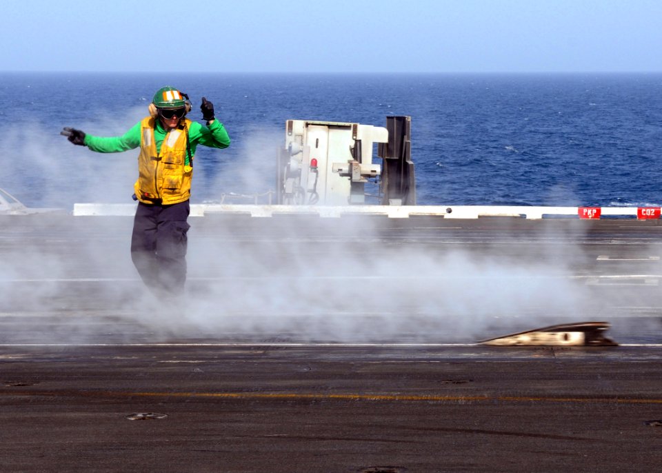 US Navy 100601-N-4236E-415 A Sailor signals for the shuttle before catapulting aircraft from USS Dwight D. Eisenhower (CVN 69)
