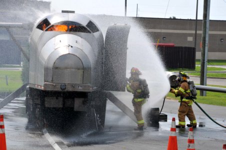 US Navy 100601-N-2468S-002 Firefighters assigned to Naval Construction Battalion Center Gulfport put out a fire during a semi-annual live aircraft fire training exercise