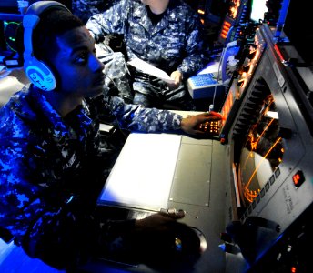 US Navy 100528-N-7317W-006 Operations Specialist 2nd Class Luis Vazquez, a strike controller aboard the Nimitz-class aircraft carrier USS Harry S. Truman (CVN 75), checks for aircraft on a radar scope in the Combat Direction Ce