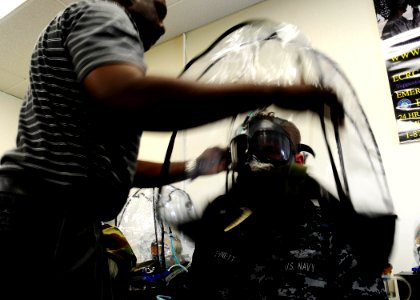 US Navy 100527-N-8607R-041 Chemical, biological and radiological Technician Kenneth Blue assists an individual augmentee Sailor in testing his gas mask at Expeditionary Combat Readiness Center San Diego