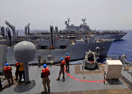 US Navy 100604-N-1082Z-031 Sailors and Marines handle lines aboard the amphibious dock landing ship USS Ashland (LSD 48)