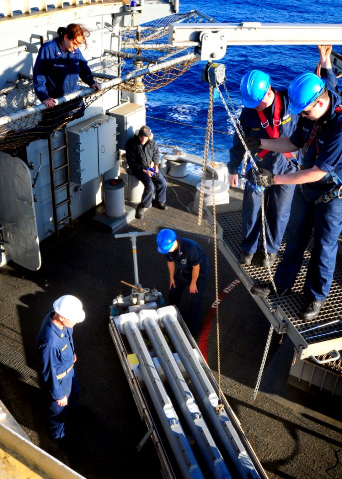 US Navy 100529-N-4378P-190 Fire Controlman 2nd Class Adam Peters lifts a missile to load into the RIM-116A Rolling Airframe Missile (RAM) system