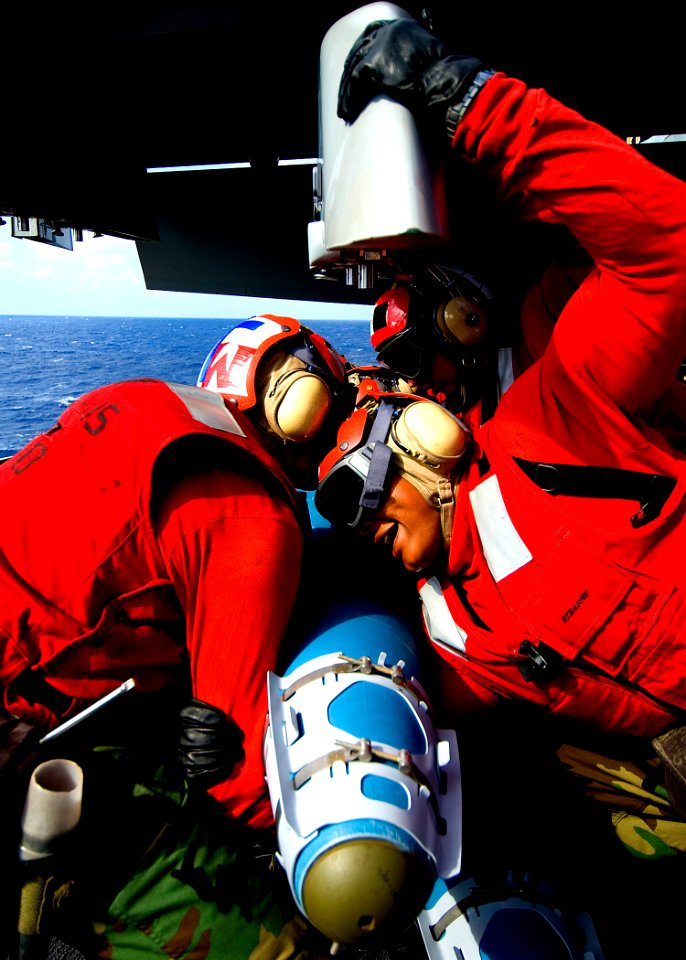US Navy 100601-N-6720T-017 Sailors prepare to lift and mount a 500 lb Guided Bomb Unit to an F-A-18F Super Hornet
