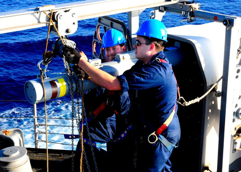 US Navy 100529-N-4378P-208 Chief Fire Controlman Jason Clarke and Fire Controlman 2nd Class Adam Peters load a missile into the RIM-116A Rolling Airframe Missile (RAM) system