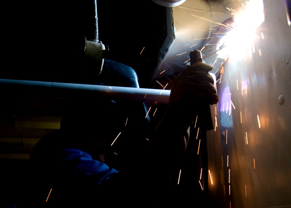 US Navy 100529-N-7191M-014 Hull Maintenance Technician 2nd Class Michael Ramirez uses an arc welder to install a new mounting bracket for a thermostat aboard USS George Washington (CVN 73)
