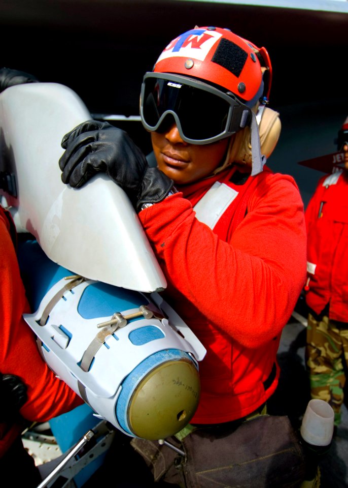 US Navy 100601-N-6720T-021 Aviation Odnanceman Airman Tavarus Franklin helps his team mount a 500 lb Guided Bomb Unit to an F-A-18 F Super Hornet
