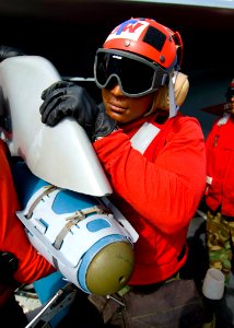 US Navy 100601-N-6720T-021 Aviation Odnanceman Airman Tavarus Franklin helps his team mount a 500 lb Guided Bomb Unit to an F-A-18 F Super Hornet