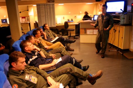 US Navy 100604-N-8907D-026 t. Cmdr. Michael Sweeney, assigned to Carrier Air Wing (CVA) 3, briefs French officers on future flight operations during a joint exercise with the French navy aircraft carrier Charles De Gaulle (R 91