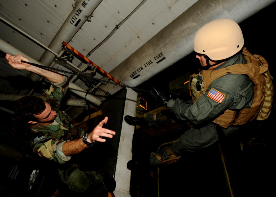 US Navy 100604-N-7191M-024 Explosive Ordnance Disposal 2nd Class Nathan Ulbrich, left, and Navy Diver 2nd Class Joshua Melius, both assigned to Explosive Ordnance Disposal Mobile Unit (EODMU) 5