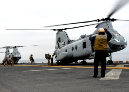 US Navy 100603-N-0515W-011 Aviation Boatswain's Mate 3rd Class Brandt Krauel directs Marines as they embark a CH-46E Sea Knight aboard the amphibious assault ship USS Bonhomme Richard (LHD 6) during Dawn Blitz 2010
