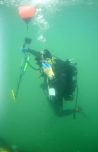 US Navy 100530-N-0413B-040 Navy Diver 2nd Class Jeremy Odell descends on a buoy line during a recovery search dive photo