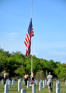 US Navy 100531-N-8241M-135 Sailors, Marines and Soldiers assigned to Naval Station Guantanamo Bay, observe morning colors at the Cuzco Wells Cemetery on the base as an observance of Memorial Day
