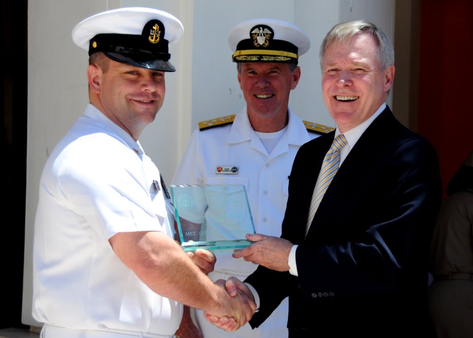 US Navy 100601-N-1512O-065 Secretary of the Navy (SECNAV) the Honorable Ray Mabus, right, presents the Enlisted Public Affairs Officer of the Year award to Chief Mass Communication Specialist Jason Morris