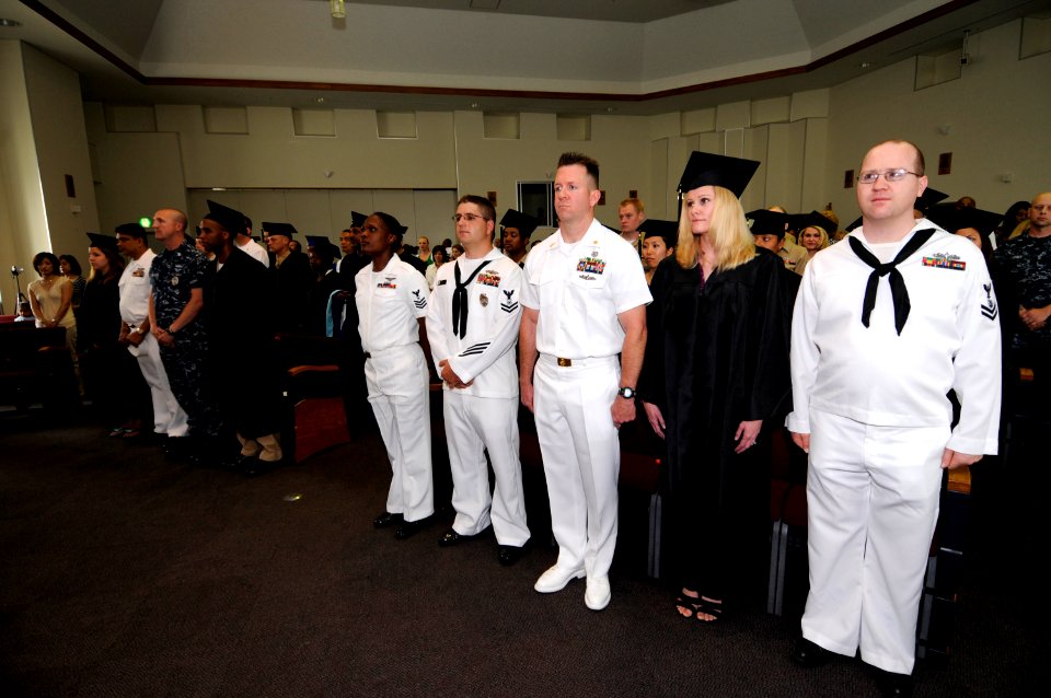 US Navy 100604-N-8335D-027 Students and guests stand during the playing of the national anthem at a Navy College graduation celebration in the main base chapel at Fleet Activities Sasebo