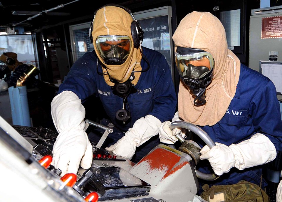 US Navy 100602-N-1082Z-036 Sailors stand watch at the ship's helm during a simulated chemical, biological and radiological attack
