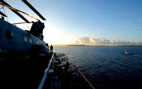 US Navy 100605-N-7948R-019 Sailors stand watch on the flight deck of the amphibious assault ship USS Peleliu (LHA 5) as it pulls into Guam for a scheduled port visit