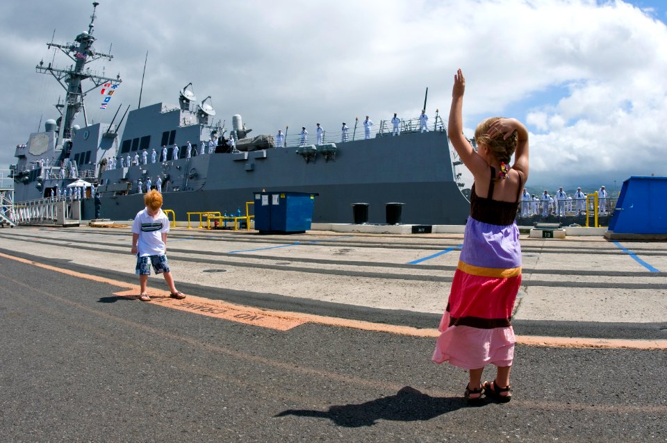 US Navy 100601-N-6674H-008 A child waves goodbye as the guided-missile destroyer USS Chung-Hoon (DDG 93) departs on a deployment to the western Pacific Ocean