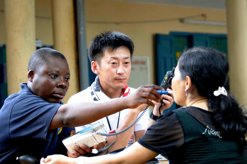 US Navy 100607-N-6410J-093 Hospital Corpsman 3rd Class Isaac Agblo, from Gaithersburg, Md., and a Japanese medical professional check a Vietnamese woman's vital signs