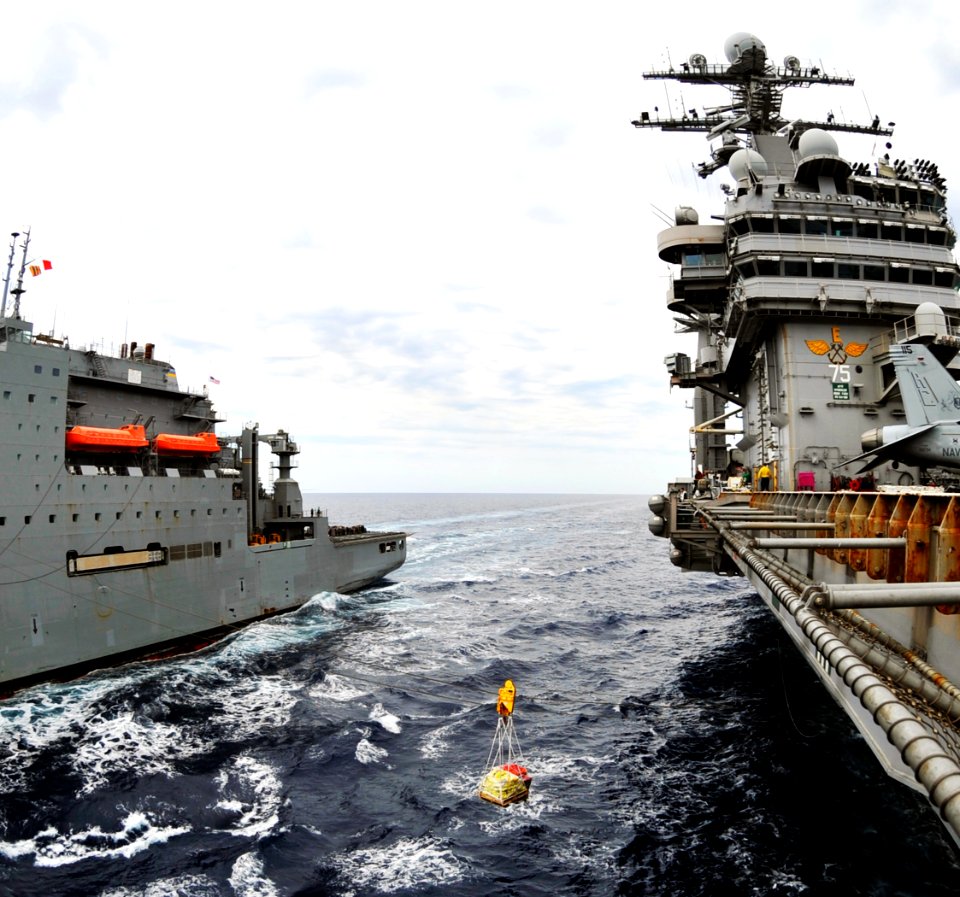 US Navy 100603-N-6003P-158 The Military Sealift Command dry cargo and ammunition ship USNS Sacagawea (T-AKE 2) transports supplies to the Nimitz-class aircraft carrier USS Harry S. Truman (CVN 75) during a replenishment at sea