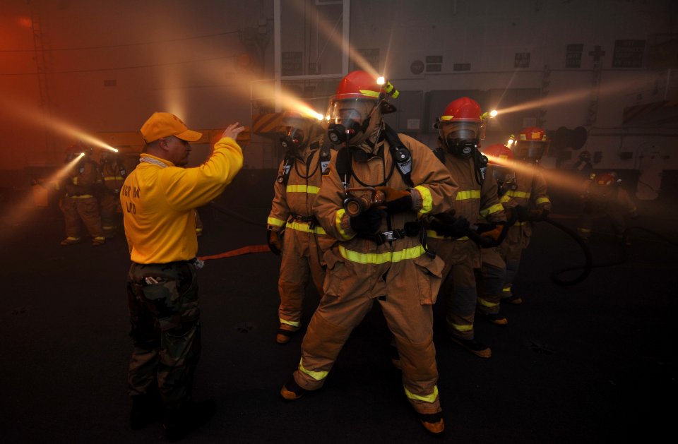 US Navy 100607-N-4516G-045 Sailors fight a simulated fire during a general quarters drill aboard USS Enterprise (CVN 65)