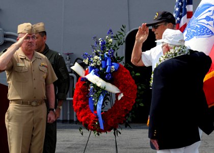 US Navy 100604-N-8913A-147 dm. John C. Harvey, Jr., left, commander of U.S. Fleet Forces Command, salute World War II veterans during a Battle of Midway commemoration ceremony aboard the aircraft carrier USS George H.W. Bush (C
