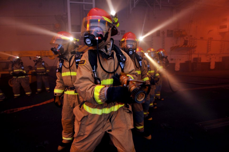 US Navy 100607-N-4516G-048 Sailors assigned to repair locker 1 F fight a simulated fire during a general quarters drill aboard the aircraft carrier USS Enterprise (CVN 65)