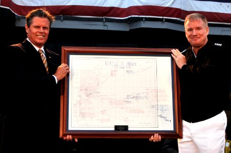 US Navy 100605-N-3038W-174 Adm. Patrick Walsh presents Rear Adm. John McLaughlin (Ret.) a framed replica of the Battle of Midway battle plans for the USS Midway (CV 41) Museum
