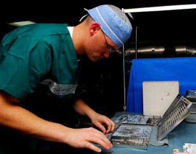 US Navy 100605-N-4044H-016 Hospital Corpsman 2nd Class Alan Kampert arranges sterilized surgical tools in an autoclave to be cleaned for use during surgeries