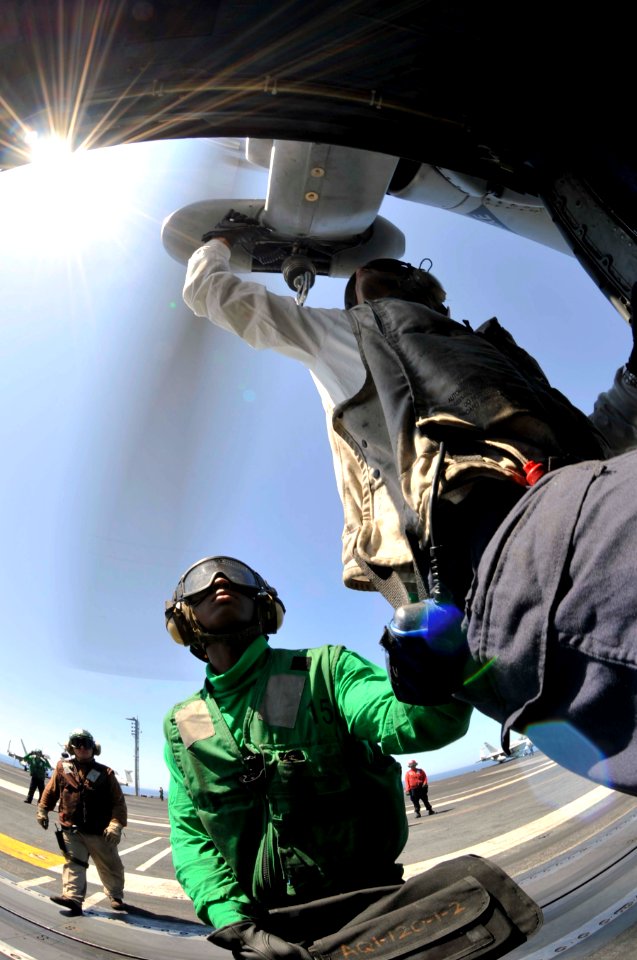 US Navy 100605-N-6003P-041 Crew members perform a final check on an SH-60F Sea Hawk helicopter assigned to the Dusty Dogs of Helicopter Anti-Submarine Squadron (HS) 7 before flight operations aboard the Nimitz-class aircraft ca