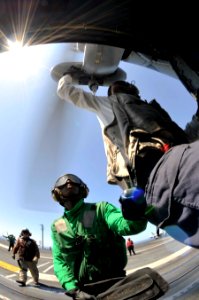 US Navy 100605-N-6003P-041 Crew members perform a final check on an SH-60F Sea Hawk helicopter assigned to the Dusty Dogs of Helicopter Anti-Submarine Squadron (HS) 7 before flight operations aboard the Nimitz-class aircraft ca